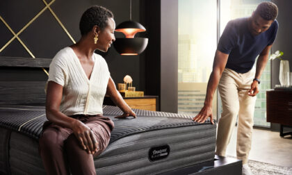 man and woman om beautyrest black mattress